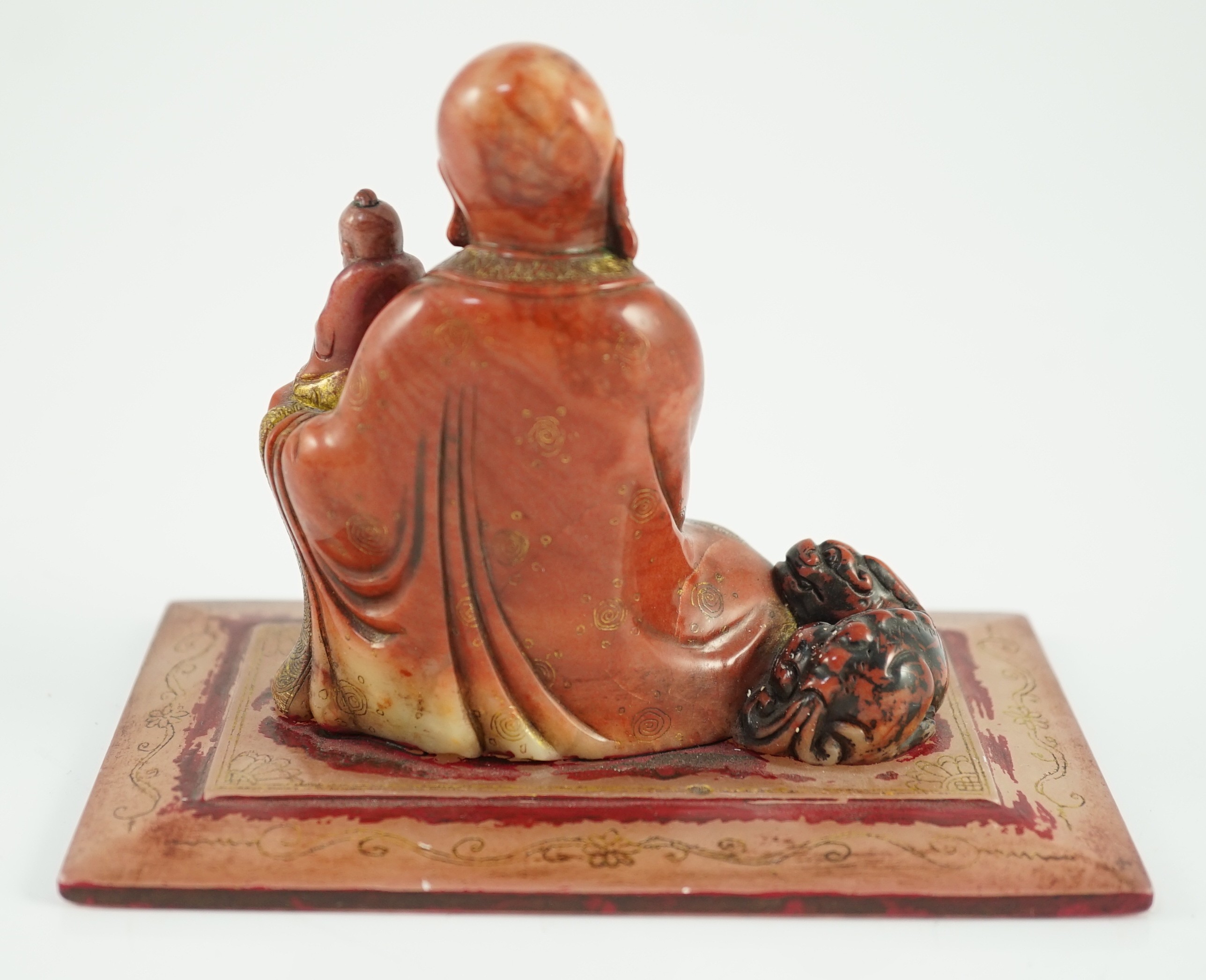 A Chinese soapstone group of a luohan holding a figure of Buddha, 18th century, 12cm wide, 9cm high